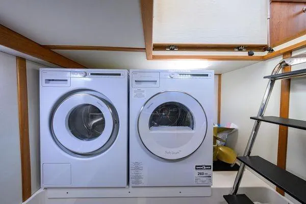  Yacht Photos Pics Laundry area inside 2022 Sabre 45 Salon Express yacht with washer and dryer.