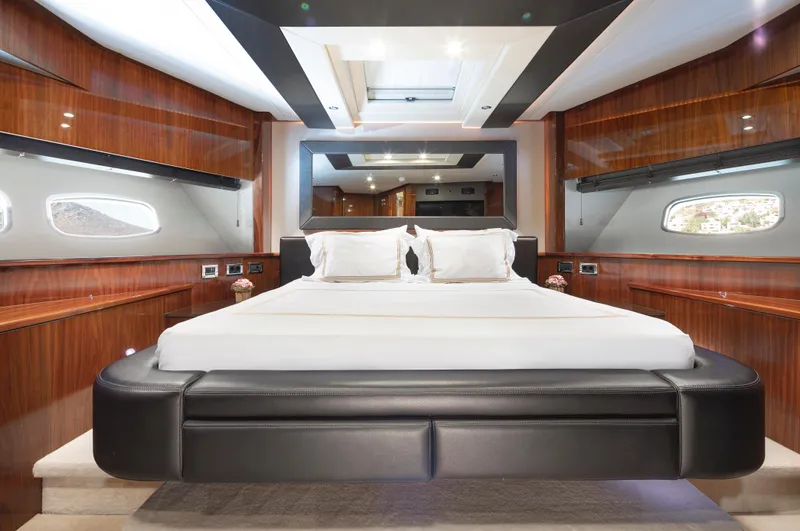 Merci Yacht Photos Pics Luxurious bedroom interior of 2010 Sunseeker 88 Yacht with elegant wood paneling.