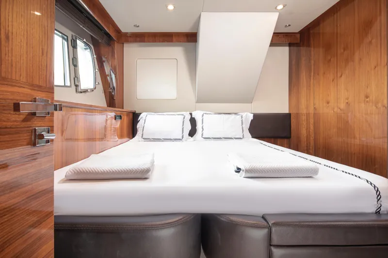 Merci Yacht Photos Pics Luxurious cabin interior of 2010 Sunseeker 88 Yacht with elegant wood paneling.