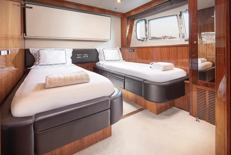 Merci Yacht Photos Pics Luxurious twin cabin interior on 2010 Sunseeker 88 Yacht, featuring elegant wood finishes.
