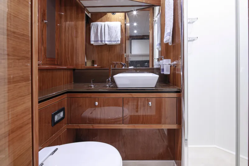 Merci Yacht Photos Pics Luxurious bathroom in 2010 Sunseeker 88 Yacht with wood finish and modern fixtures.