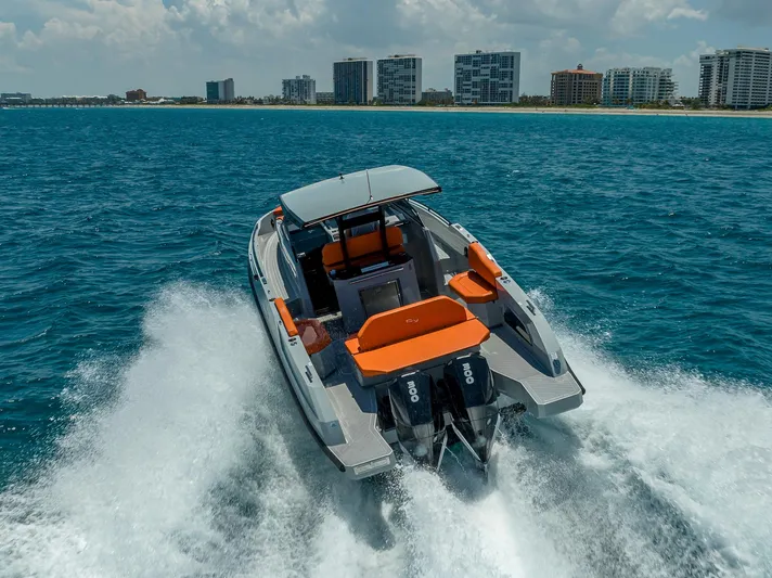  Yacht Photos Pics 2024 Rio Yachts Daytona 35 cruising on ocean near city skyline.