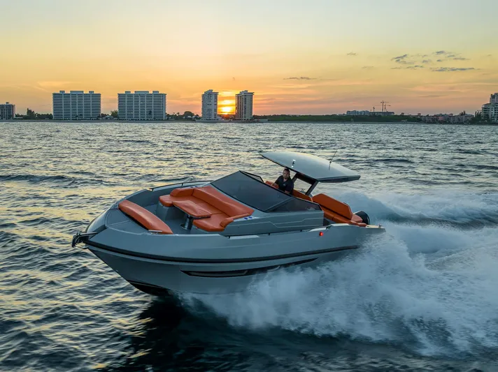  Yacht Photos Pics 2024 Rio Yachts Daytona 35 cruising at sunset near city skyline.