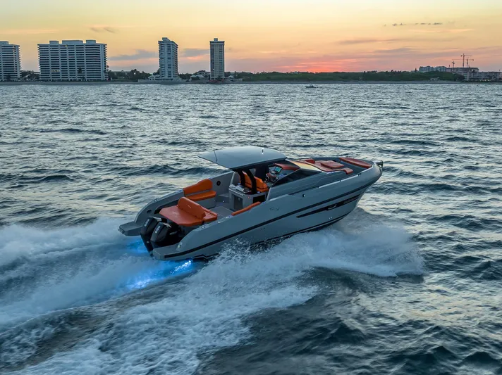  Yacht Photos Pics 2024 Rio Yachts Daytona 35 cruising at sunset near city skyline.