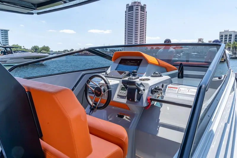  Yacht Photos Pics 2024 Rio Yachts Daytona 35 cockpit with orange seating and modern controls, docked by waterfront.