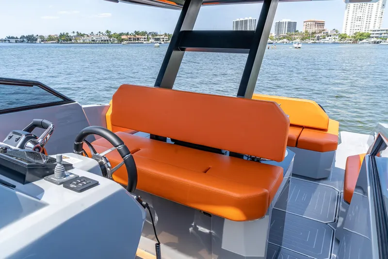  Yacht Photos Pics 2024 Rio Yachts Daytona 35 with orange seating, steering wheel, and waterfront view.