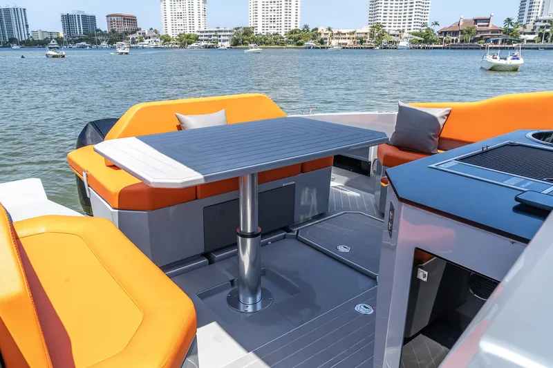  Yacht Photos Pics 2024 Rio Yachts Daytona 35 interior with orange seating and table, overlooking waterfront.