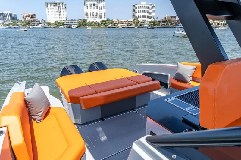  Yacht Photos Pics 2024 Rio Yachts Daytona 35 with vibrant orange seating, docked near waterfront buildings.
