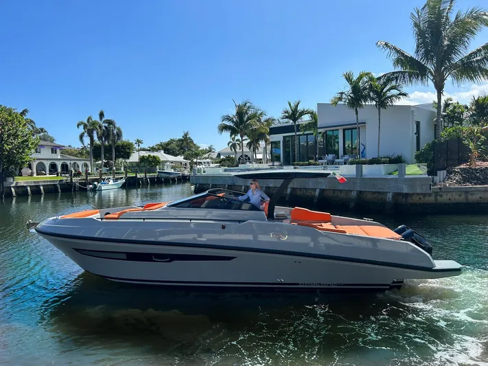  Yacht Photos Pics 2024 Rio Yachts Daytona 35 cruising in a sunny, tropical canal setting.