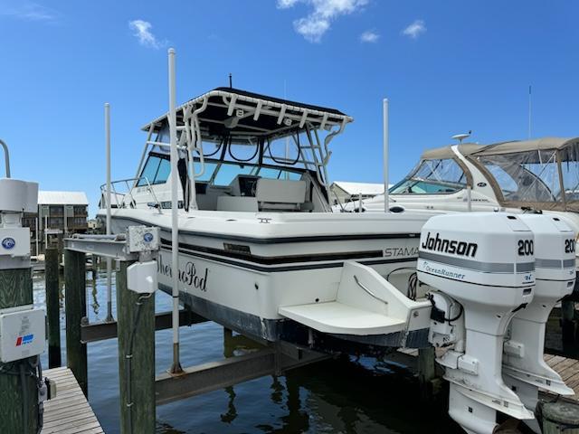 1992 Stamas 288 Liberty boat with dual Johnson 200 engines docked at a marina.