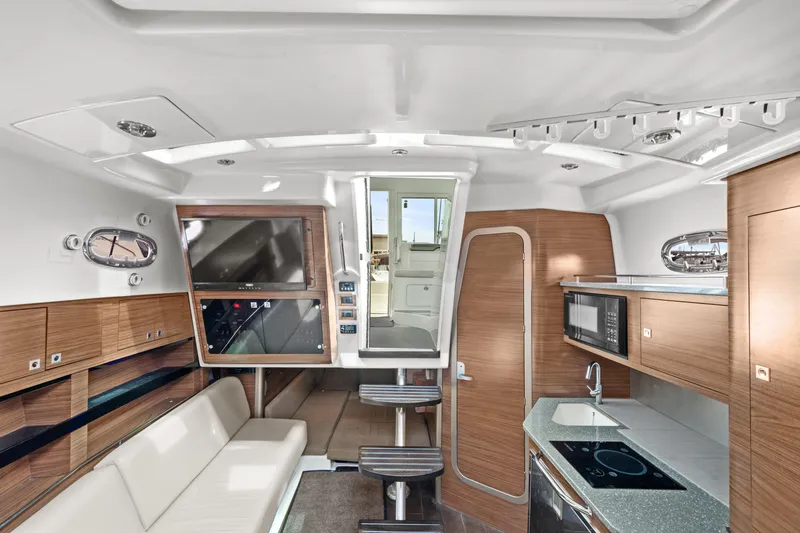  Yacht Photos Pics Interior of 2017 Boston Whaler 345 Conquest Pilothouse with modern kitchen and seating area.