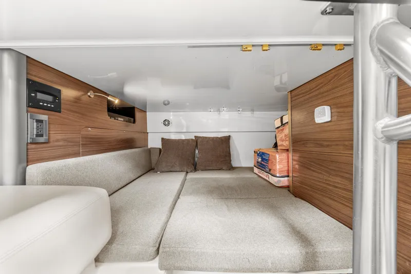  Yacht Photos Pics 2017 Boston Whaler 345 Conquest Pilothouse cabin interior with cushioned seating and wooden paneling.