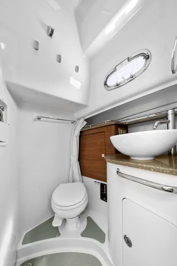 Yacht Photos Pics 2017 Boston Whaler 345 Conquest Pilothouse bathroom with modern fixtures and porthole window.