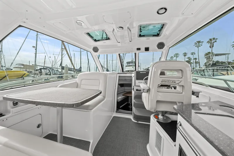  Yacht Photos Pics Interior of 2017 Boston Whaler 345 Conquest Pilothouse with seating and table.
