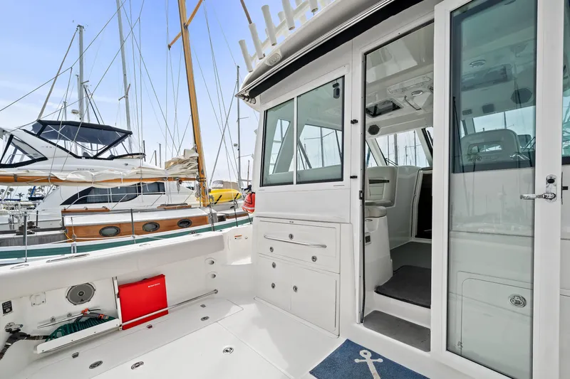  Yacht Photos Pics 2017 Boston Whaler 345 Conquest Pilothouse interior and deck view at marina.