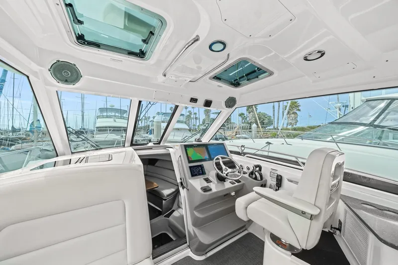  Yacht Photos Pics 2017 Boston Whaler 345 Conquest Pilothouse interior with modern helm and navigation equipment.