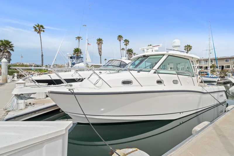  Yacht Photos Pics 2017 Boston Whaler 345 Conquest Pilothouse docked at marina with palm trees.