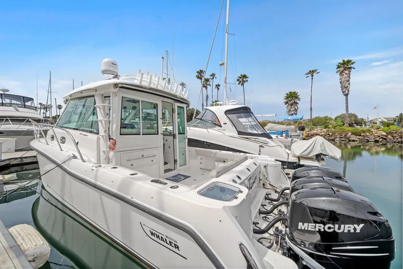  Yacht Photos Pics 2017 Boston Whaler 345 Conquest Pilothouse docked with Mercury outboard engines.
