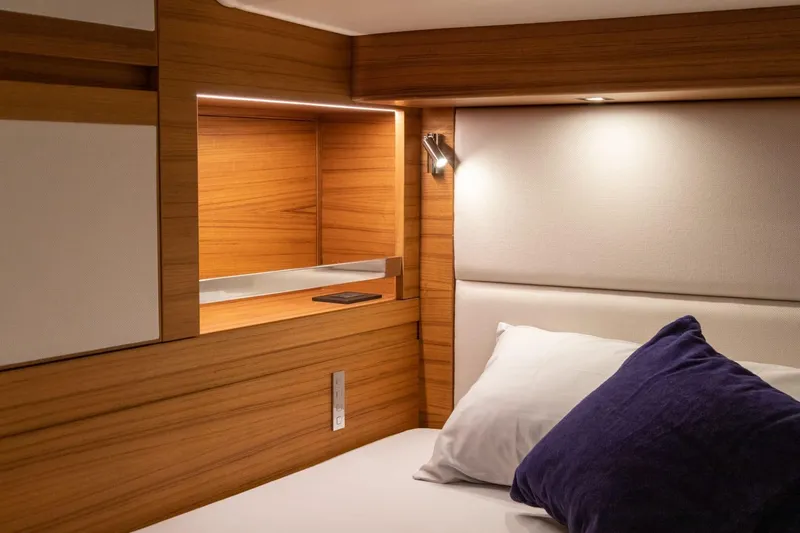  Yacht Photos Pics Luxurious cabin interior of 2026 Ice Yachts 70, featuring wooden accents and cozy bedding.