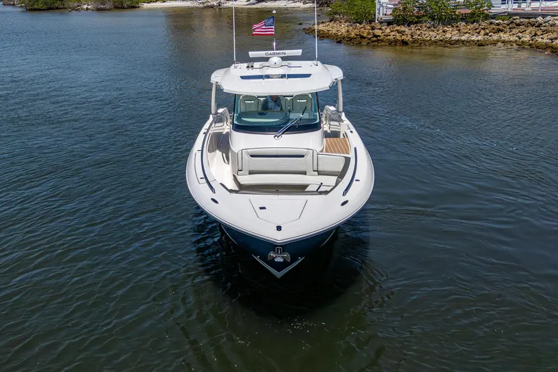 Let It Ride Yacht Photos Pics 2024 Tiara Yachts 38 LS boat on calm water, front view with American flag.