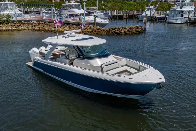 Let It Ride Yacht Photos Pics 2024 Tiara Yachts 38 LS luxury boat docked in a marina, featuring sleek design and spacious deck.