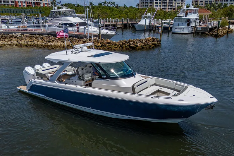 Let It Ride Yacht Photos Pics 2024 Tiara Yachts 38 LS luxury boat docked in a marina, featuring sleek design and modern amenities.