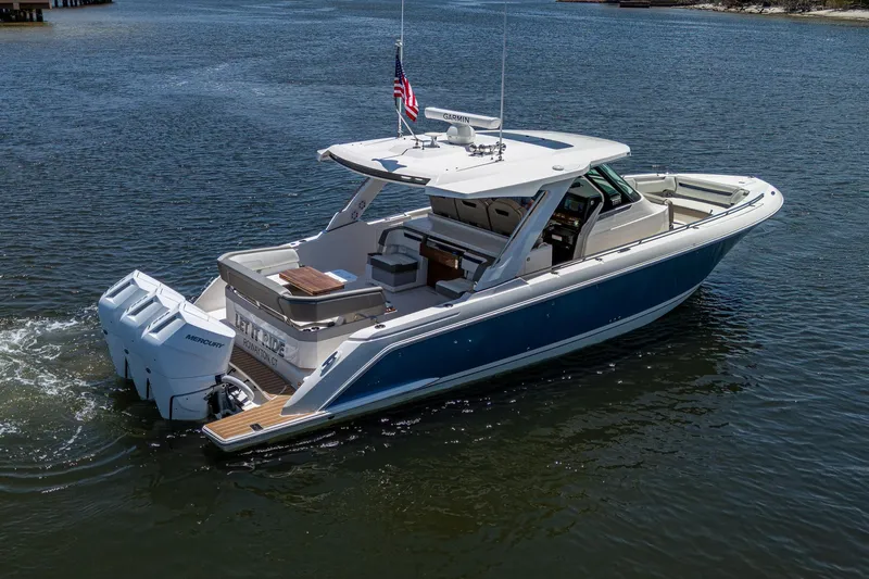 Let It Ride Yacht Photos Pics 2024 Tiara Yachts 38 LS cruising on calm waters, showcasing sleek design and powerful engines.