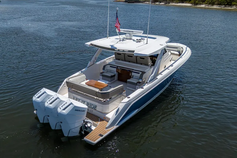 Let It Ride Yacht Photos Pics 2024 Tiara Yachts 38 LS luxury boat on calm water, rear view.