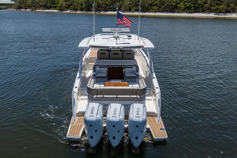 Let It Ride Yacht Photos Pics 2024 Tiara Yachts 38 LS with triple outboard engines on a calm waterway.
