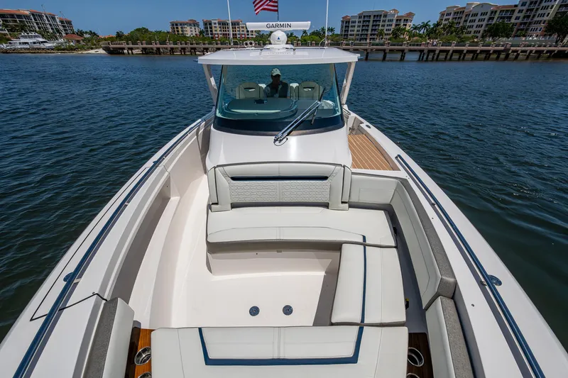 Let It Ride Yacht Photos Pics 2024 Tiara Yachts 38 LS luxury boat on calm water, featuring spacious seating and sleek design.