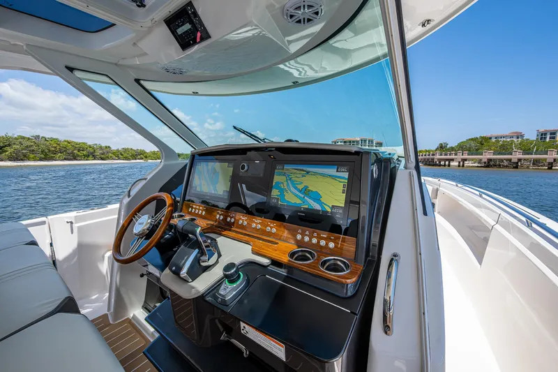 Let It Ride Yacht Photos Pics 2024 Tiara Yachts 38 LS helm with advanced navigation system and luxurious interior.