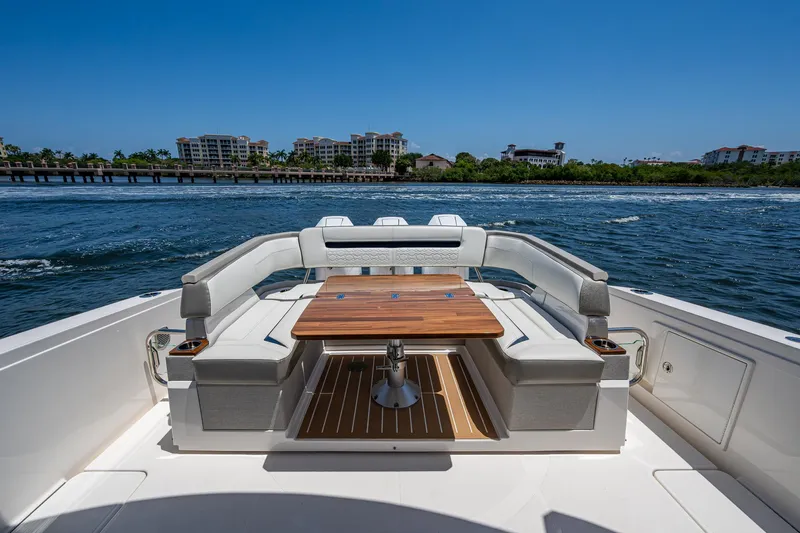 Let It Ride Yacht Photos Pics 2024 Tiara Yachts 38 LS luxury yacht with elegant seating and wooden table on open water.