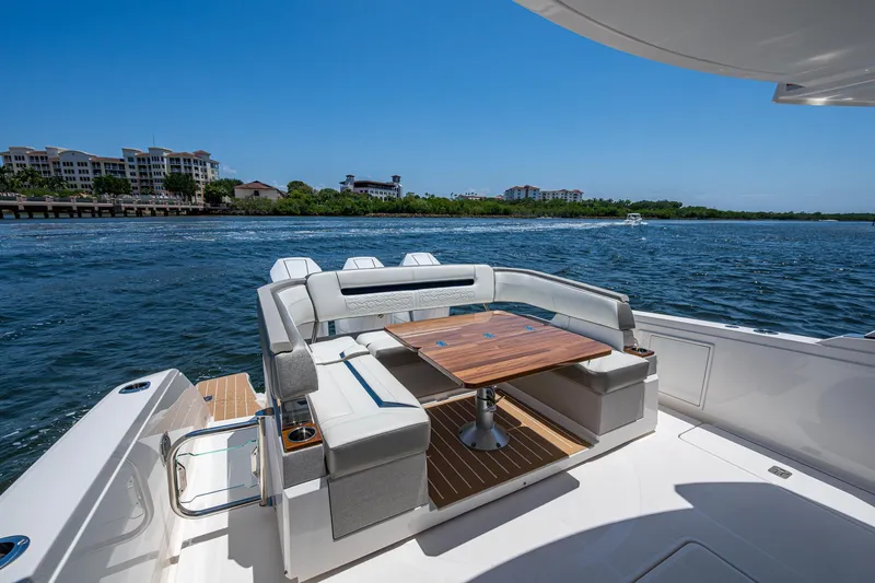 Let It Ride Yacht Photos Pics 2024 Tiara Yachts 38 LS with elegant seating and table, cruising on a sunny day.