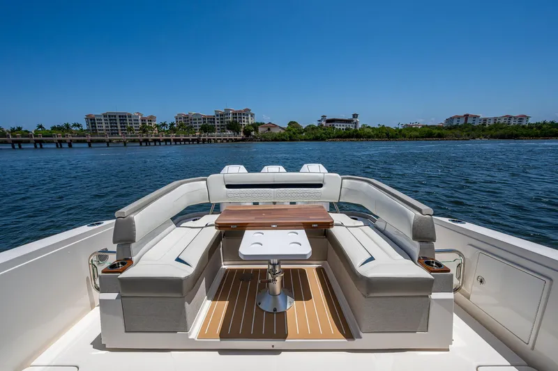 Let It Ride Yacht Photos Pics 2024 Tiara Yachts 38 LS luxury yacht with elegant seating and scenic waterfront view.
