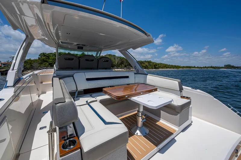 Let It Ride Yacht Photos Pics 2024 Tiara Yachts 38 LS luxury boat interior with seating and table, on a sunny day.