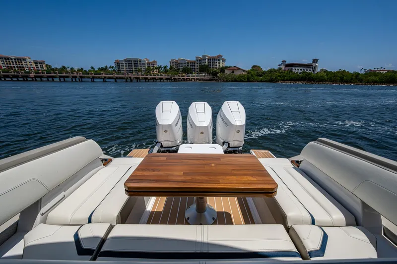 Let It Ride Yacht Photos Pics 2024 Tiara Yachts 38 LS with triple engines, luxurious seating, and wooden table on open water.