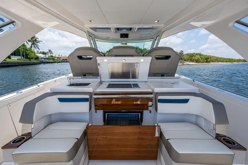 Let It Ride Yacht Photos Pics 2024 Tiara Yachts 38 LS interior with seating and outdoor kitchen on a sunny day.