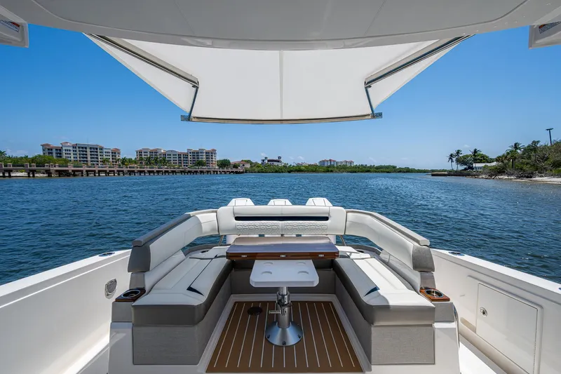 Let It Ride Yacht Photos Pics 2024 Tiara Yachts 38 LS luxury yacht with spacious seating and scenic waterfront view.