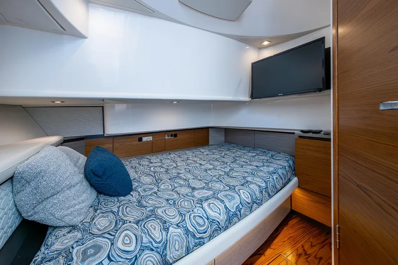 Let It Ride Yacht Photos Pics 2024 Tiara Yachts 38 LS cabin interior with bed, TV, and modern design.