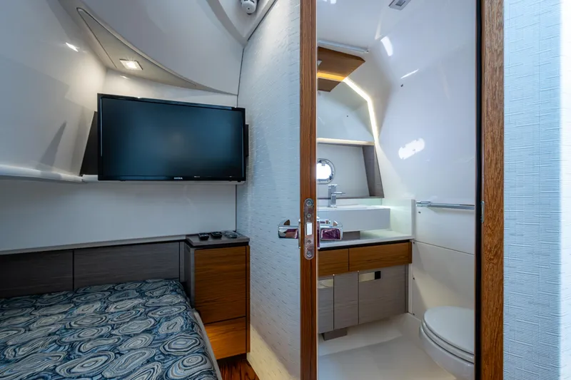 Let It Ride Yacht Photos Pics 2024 Tiara Yachts 38 LS interior with bed, TV, and modern bathroom.