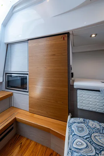 Let It Ride Yacht Photos Pics 2024 Tiara Yachts 38 LS interior with modern wood finishes and cozy seating.