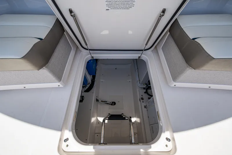 Let It Ride Yacht Photos Pics 2024 Tiara Yachts 38 LS storage compartment with open hatch and cushioned seating.