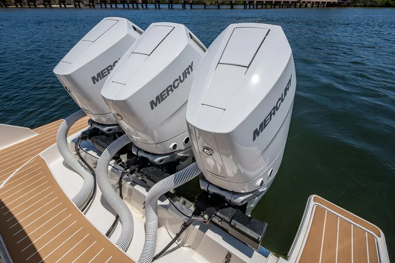 Let It Ride Yacht Photos Pics Triple Mercury outboard engines on 2024 Tiara Yachts 38 LS, docked on water.