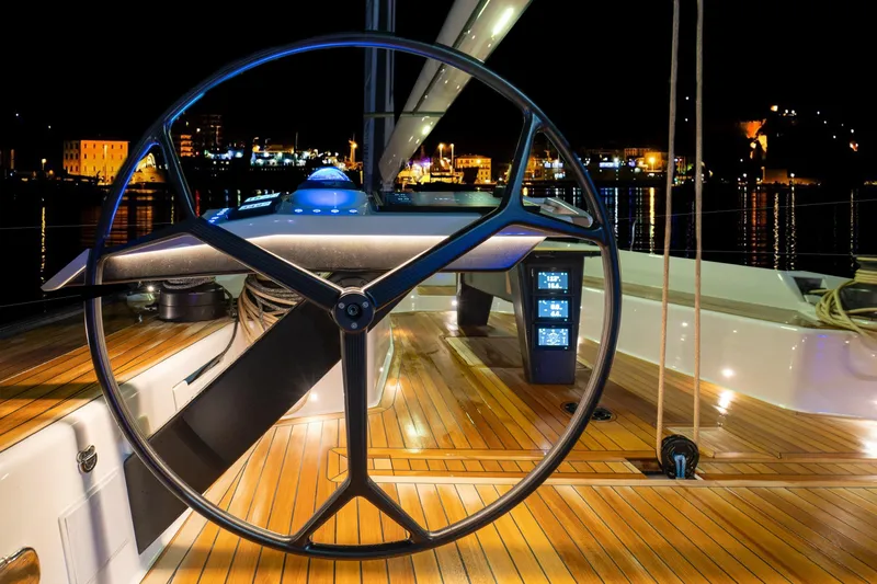  Yacht Photos Pics Steering wheel of 2026 Ice Yachts 70, illuminated at night with city lights in background.