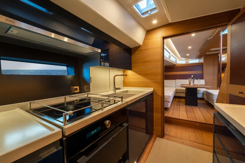  Yacht Photos Pics Luxurious interior of 2026 Ice Yachts 70, featuring modern kitchen and elegant seating area.