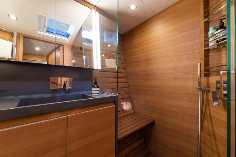  Yacht Photos Pics Luxurious bathroom interior of 2026 Ice Yachts 70, featuring sleek wood paneling and modern fixtures.