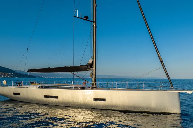  Yacht Photos Pics Luxury Ice Yachts 70 sailing on calm sea, 2026 model, under clear blue sky.