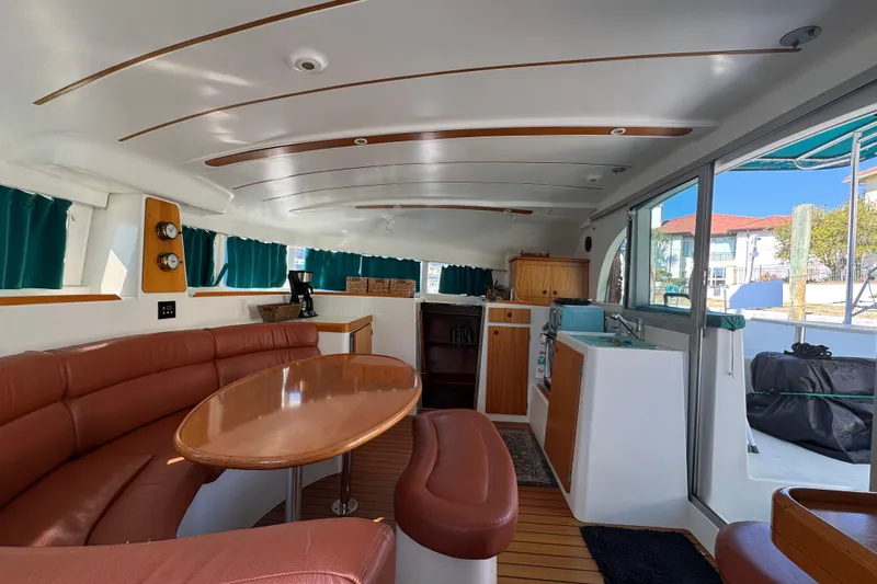Wayward Sun Yacht Photos Pics Interior of 2000 Lagoon 380 catamaran with cozy seating and modern amenities.