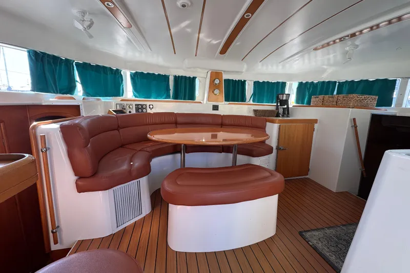 Wayward Sun Yacht Photos Pics Interior of 2000 Lagoon 380 catamaran with leather seating and wooden accents.