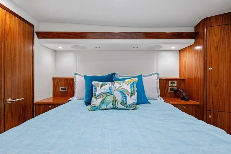 Galati Yacht Sales Trade Yacht Photos Pics Luxurious bedroom interior of 2025 Viking 58 Convertible yacht with elegant wood finish.